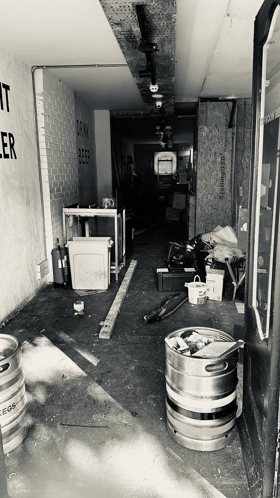 The derelict former beer and burger site at 464 Kingsland Road before the rebuild - kegs, tools and bare walls